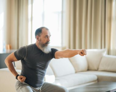 a man in black crew neck t shirt and gray pants doing an exercise